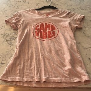 This is a pink shirt that says camp vibes. It’s very cute.